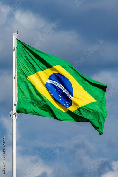 Obraz The Brazilian flag fluttering on the pole. Blue sky.