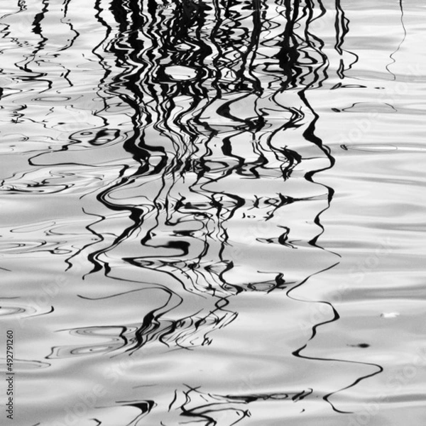 Fototapeta Zoom background. Abstract background. Reflections spreading on colorless water and dissipating into surreal imaginary forms, close view. 