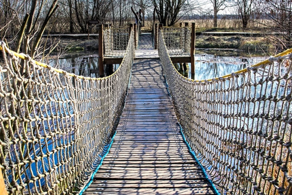 Obraz Suspension bridge over the lake water
