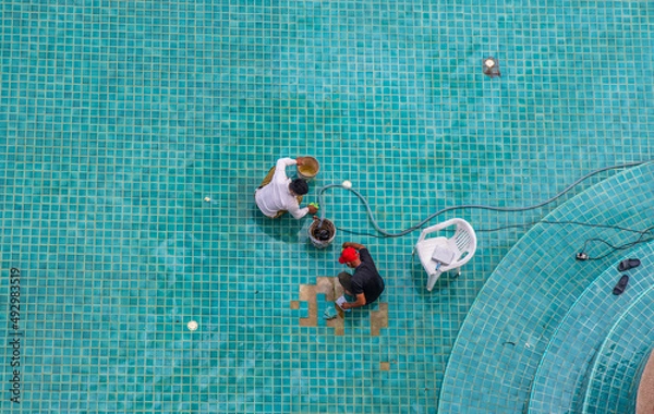 Fototapeta Renovation, maintenance, repair, and tiling work of a swimming pool 