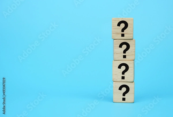 Fototapeta wooden block with question mark symbol on blue background, element of banner design concept. 