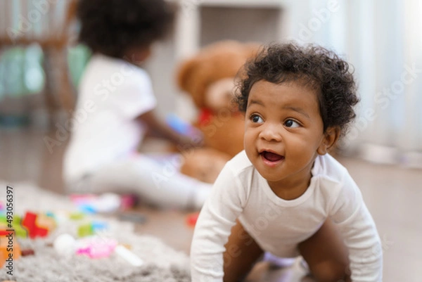 Fototapeta Happy African American Little baby boy crawling and looking for some thing to learn