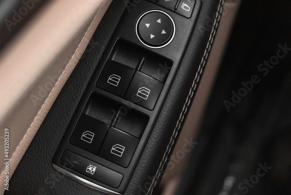 Fototapeta Window buttons inside luxury car. Automatic power controlling system close-up view
