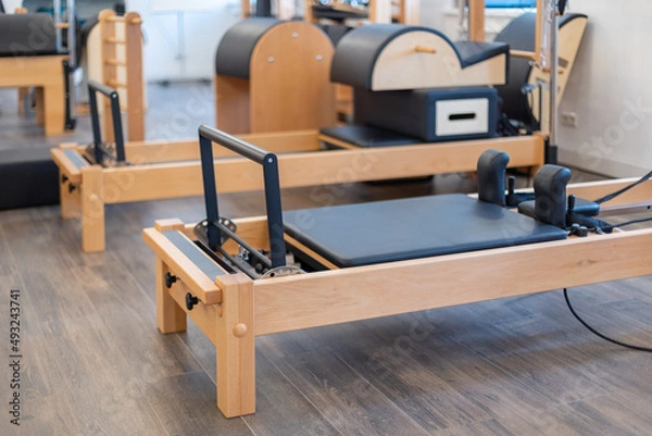 Obraz Fitness pilates stretch tables and other exercise equipment in gym. High quality photo