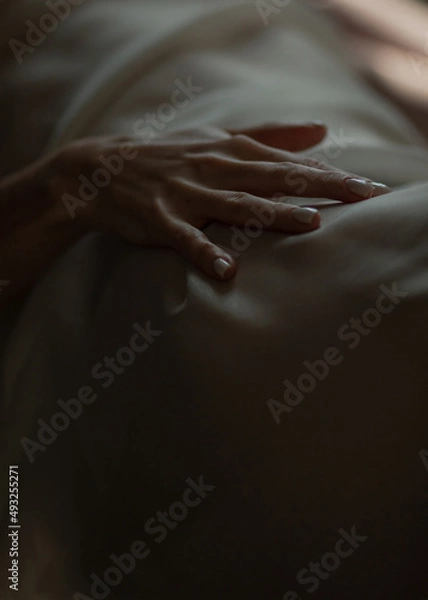 Fototapeta Close-up of a woman's hand. Gentle and sensual movement. Female attractiveness and temptation. Soft focus and beautiful bokeh.