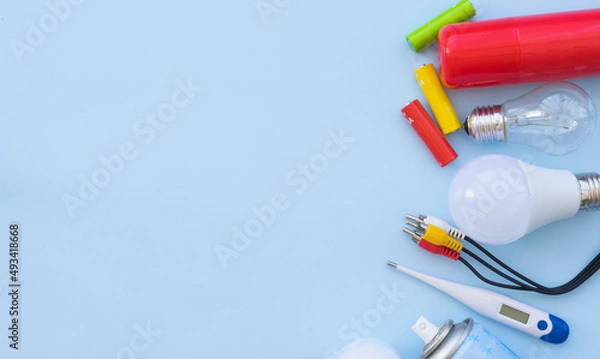 Fototapeta Environmentally hazardous household waste on a light blue background