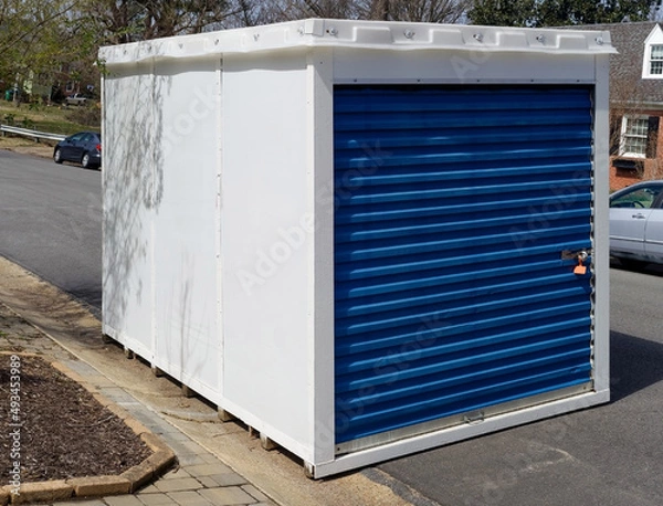 Fototapeta Temporary storage unit at curbside in residential neighborhood.