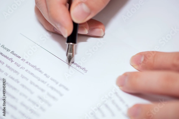 Obraz Close up of hand writing on contract 