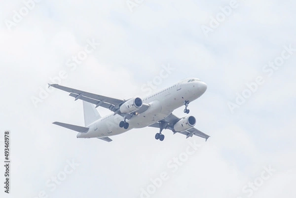Obraz Unspecified white plane on white cloud sky.