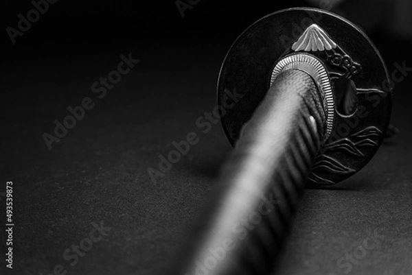 Fototapeta Tsuba (garda) katana japanese sword close-up on a black background