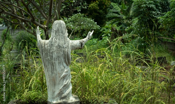 Obraz Statue of Jesus Christ from the back in the grave yard