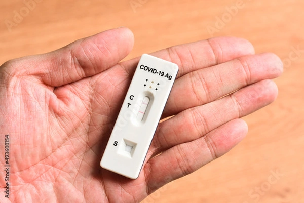 Fototapeta ATK Antigen Rapid Test Kit with Positive Result Detected of Covid-19 Virus on hand