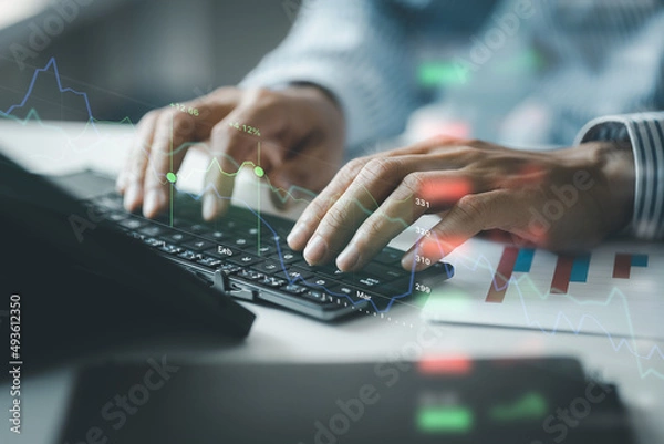 Fototapeta Close-up of hands resting on keyboard to view financial data, business growth in the world of cryptocurrencies and the current global economy with war and volatility. Finance and investment concepts.