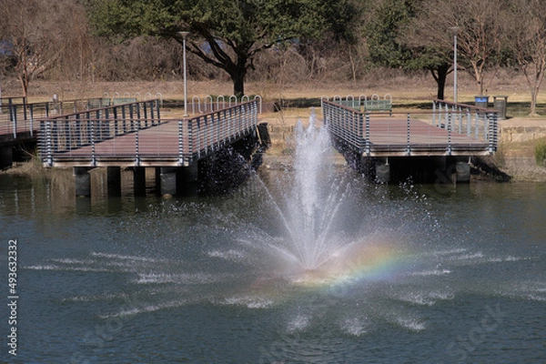 Fototapeta a rainbow being created by a fountain
