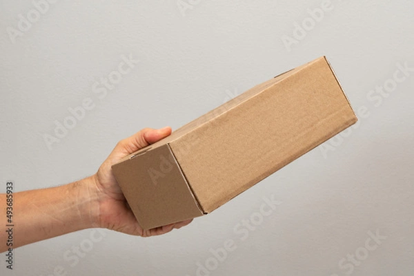 Obraz hand holding box to pack product to be sent by mail with copy space