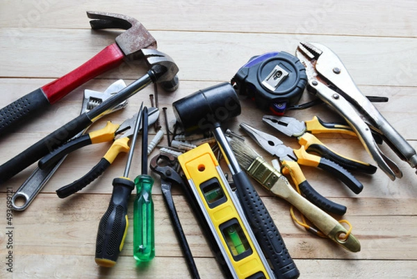 Obraz Hardware and many different tools basic instruments in general mechanic work on wooden background.