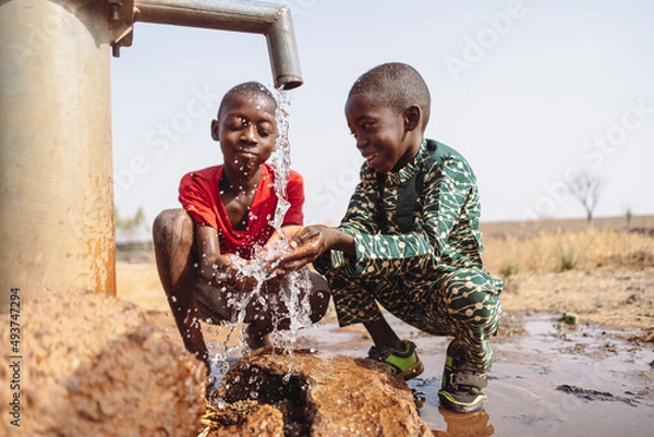 Obraz African young children drinking fresh clean water from a tap.