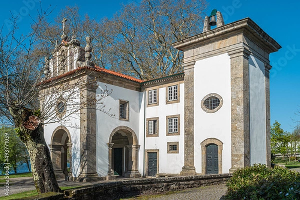 Fototapeta Church and roman bridge in Ponte de Lima, Oldest city in Portugal. It is named for a long medieval bridge that runs across the Lima River. 18th C. Sao Francisco church.