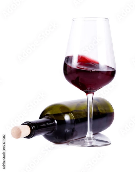 Fototapeta wine glass with red wine and lying bottle of wine