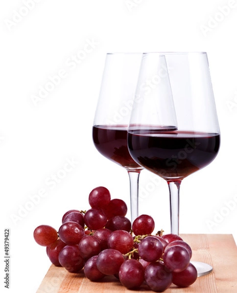 Fototapeta two wine glasses with red wine and grapes