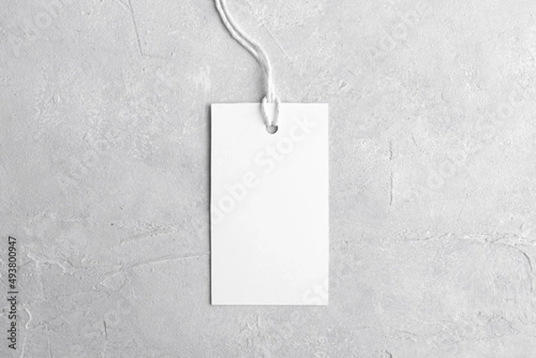 Obraz Rectangle white tag mockup with white cord, close up. Blank paper rectangular price tag mockup isolated on grey background with copy space, Sale and Black Friday concept