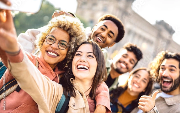 Fototapeta International guys and girls taking photo out side in Barcelona - Happy life style concept on young multiracial college students having fun day together at university yard - Bright faces warm filter