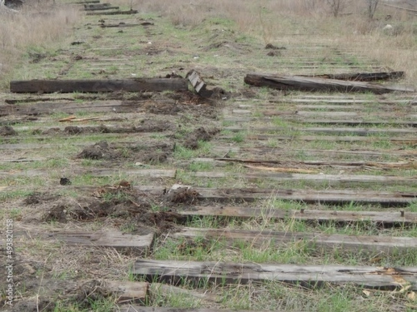 Obraz Wooden sleepers. 
Old destroyed railway tracks. 
