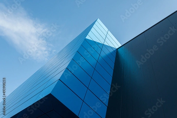 Fototapeta Geometric colored building facade elements with planes, lines and corners with light flare and reflections for an abstract background and texture of white, blue, gray colors. Place for text