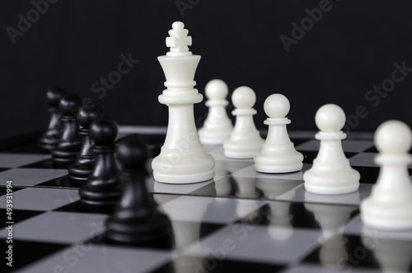 Fototapeta business strategy chess game. business leader concept.Selective focus.on a dark background.