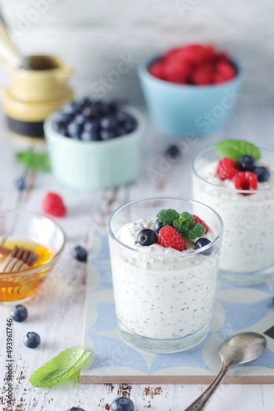 Obraz Greek yogurt in glasses with berries and quinoa