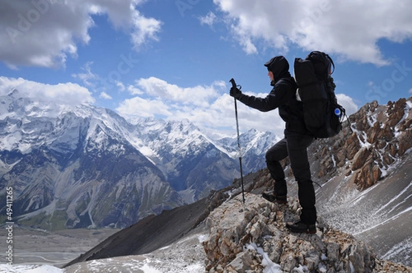 Obraz Young woman enjoys spectacular view to high mountains