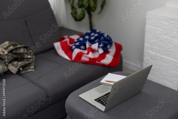 Fototapeta Soldier working with laptop in headquarters building