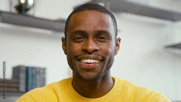 Fototapeta Young man looking at laptop by video link close-up. Man communicating on video