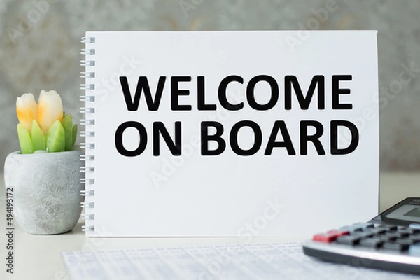 Fototapeta Welcome on board inscription on the notebook on the table, business concept