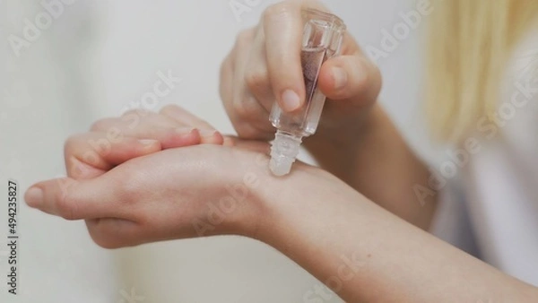 Obraz Close-up of an unrecognizable girl applying perfume on her wrist