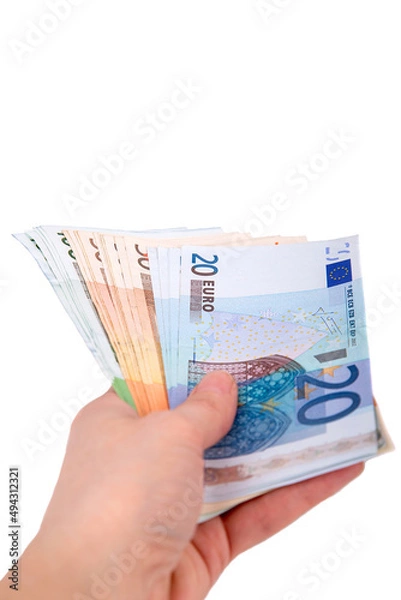 Fototapeta A man holds out a wad of euros in his hand on a white background close-up