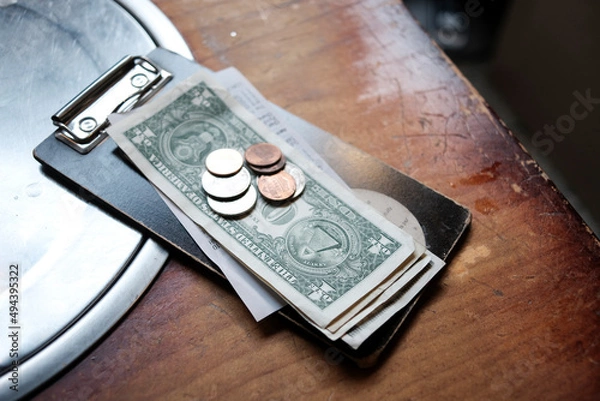 Fototapeta Tip money on restaurant's table.Change money on table