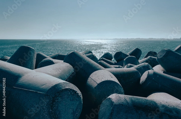 Fototapeta View from the Diga Sottomarina pier. Concrete breakwater with the blue sea background meeting the horizon. Seascape.