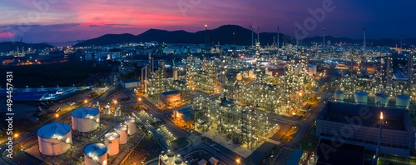 Fototapeta Aerial view. Oil refinery factory and oil storage tank at twilight and night. Banner panorama background	