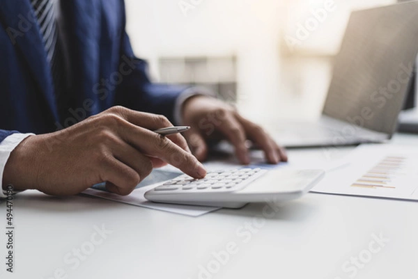 Fototapeta Accountant or banker making calculations. Money savings concept investment economy analysis. Business Financing Accounting Banking Concept