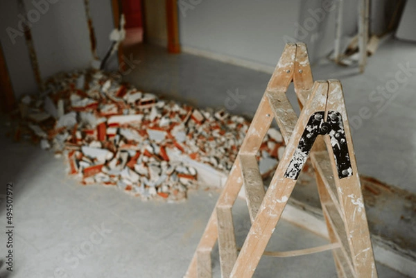 Fototapeta ladder and debris at home construction site. Home renovation
