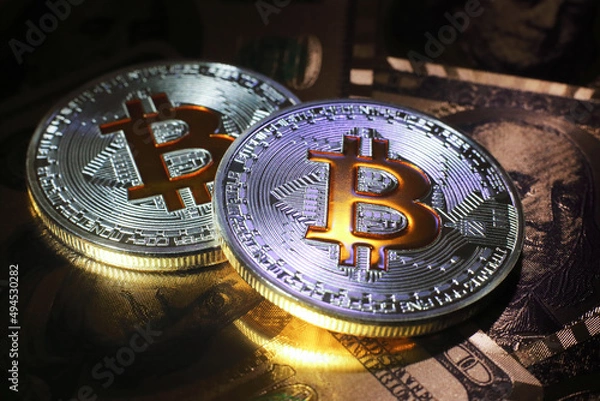 Fototapeta Bitcoin on dollar background, conceptual image for crypto currency.