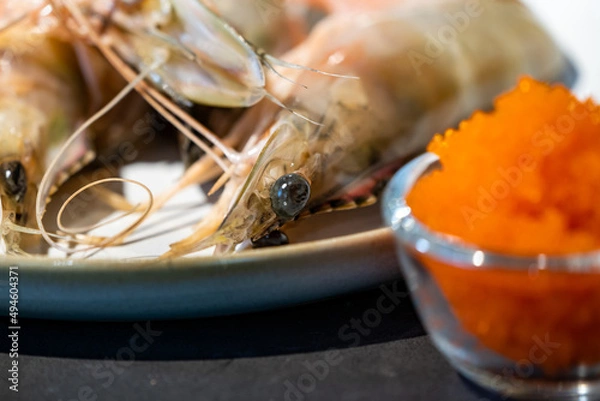 Fototapeta Focused on fresh Shrimp eye with blur tobiko beside.