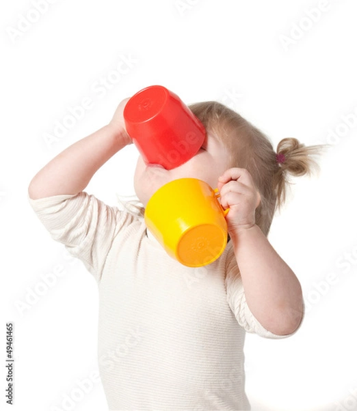 Fototapeta Child drinks juice from a mug.