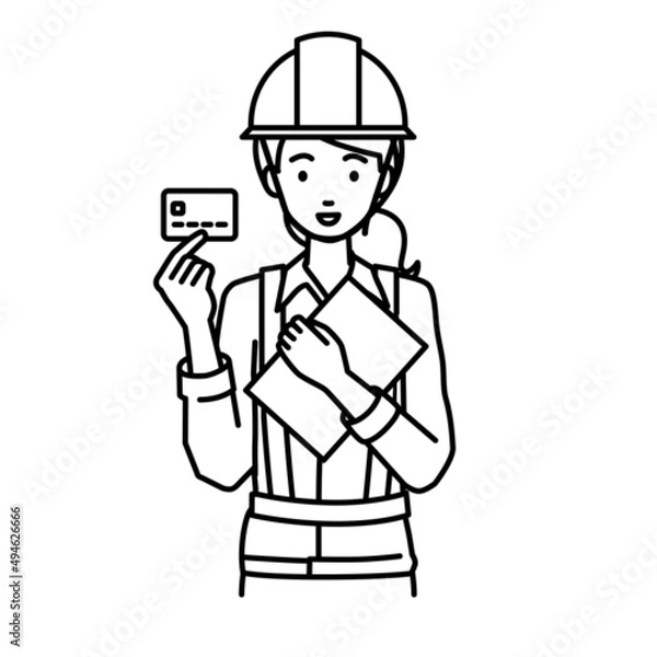 Obraz 立って書類とカードを手に持つ工事現場の女性