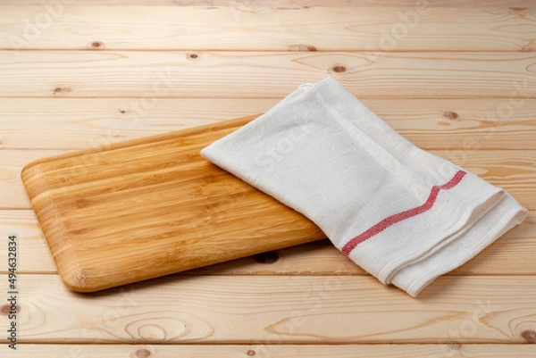 Obraz Cutting board with cotton napkin on wooden table