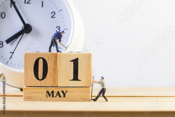Fototapeta May 1st. Day 1 of month.  Miniature worker wooden block  calendar. labor day's concept.