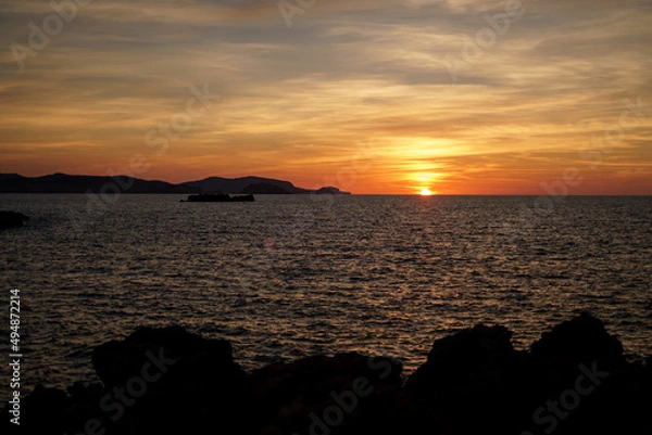 Fototapeta Cala Viola de Ponent, Menorca. September 2021. Magnificent sunset in the Mediterranean Sea. On one of the paradisaical beaches of the island of Menorca.