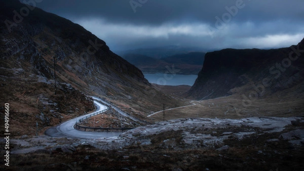 Fototapeta Moody sky over Applecross pass in Scotland. Beautiful view on NC500 road trip. Dark and moody landscape scenery.