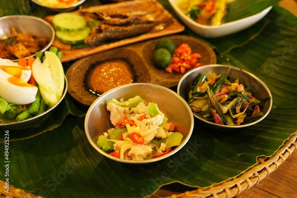 Fototapeta A complete ambuyat set with condiments, hinava, sambal, bamboo shoot, soup and basing fish (deep fried fish), a kadazan dusun traditional set.